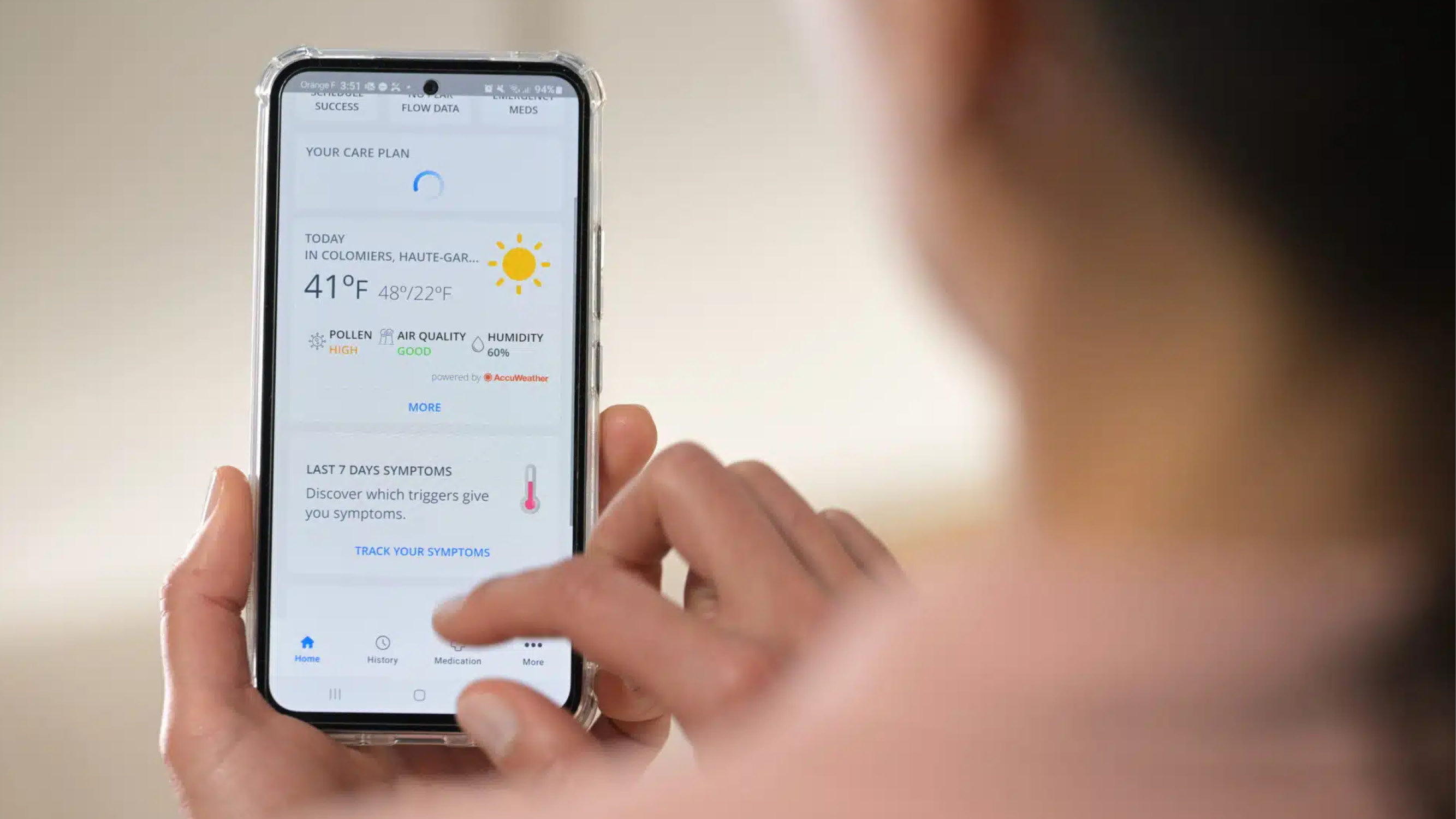 User interacting with a digital health app on a smartphone to manage symptoms and treatment adherence.